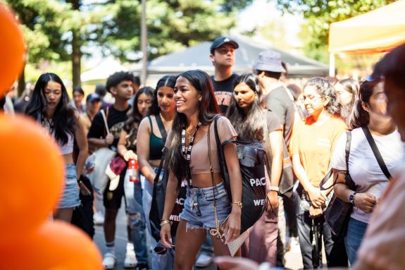 students walking with orange balloons everywhere